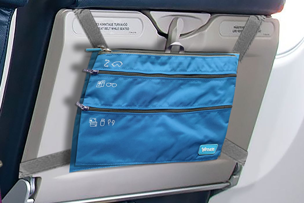Airplane cabin with blue seats and a purple bag on a tray table, featuring text about organization solutions.